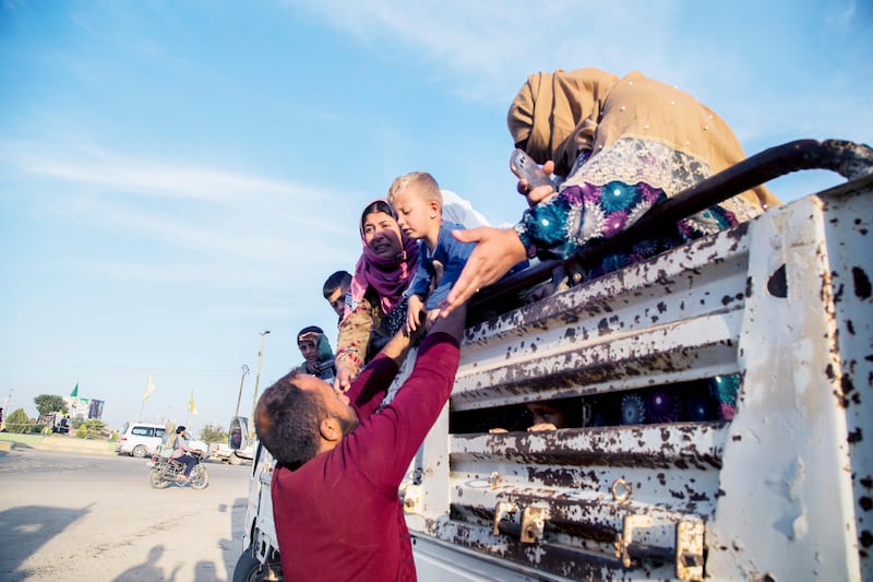 Syrians fleeing Turskih advance arrive to the town of Tal Tamr in north Syria, Monday, Oct. 14, 2019. Syrian government troops moved into towns and villages in northern Syria on Monday, setting up a potential clash with Turkish-led forces advancing in the area as long-standing alliances in the region begin to shift or crumble following the pullback of U.S. forces. (AP Photo/Baderkhan Ahmad)  DV105