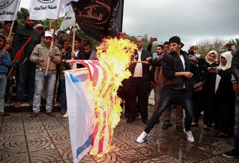 I protest mot det eventuella amerikanska beslutet att erkänna Jerusalem som Israels huvudstad bränner palestinska demonstranter israeliska och amerikanska flaggor. 