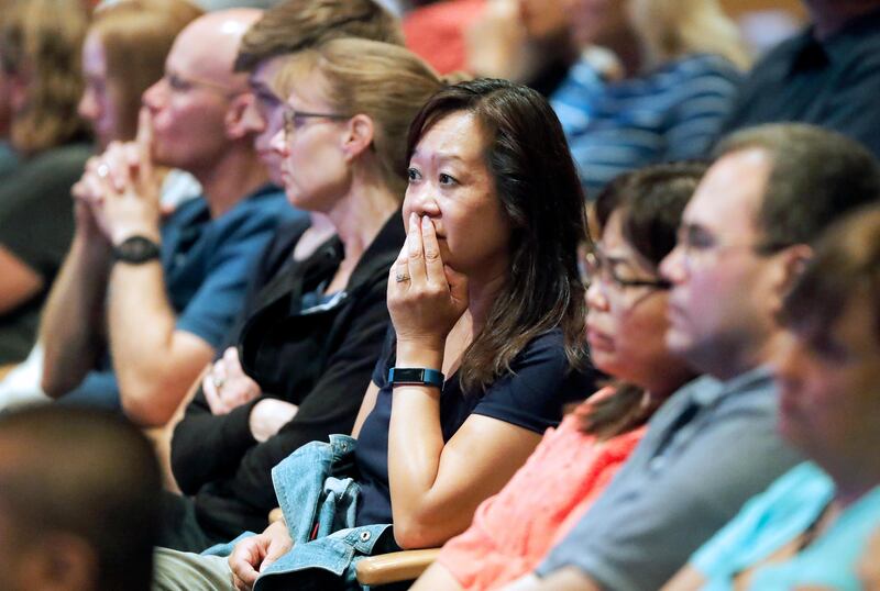 Audience members react as it was announced, Wednesday, Aug. 8, 2018, at Willow Creek Community Church in South Barrington, Ill., that lead pastor Heather Larson is stepping down, and the entire Board of Elders will do so by the end of the year. Larson said the church needed new leadership in the wake of sexual harassment allegations against church founder Bill Hybels. (Steve Lundy/Daily Herald via AP)